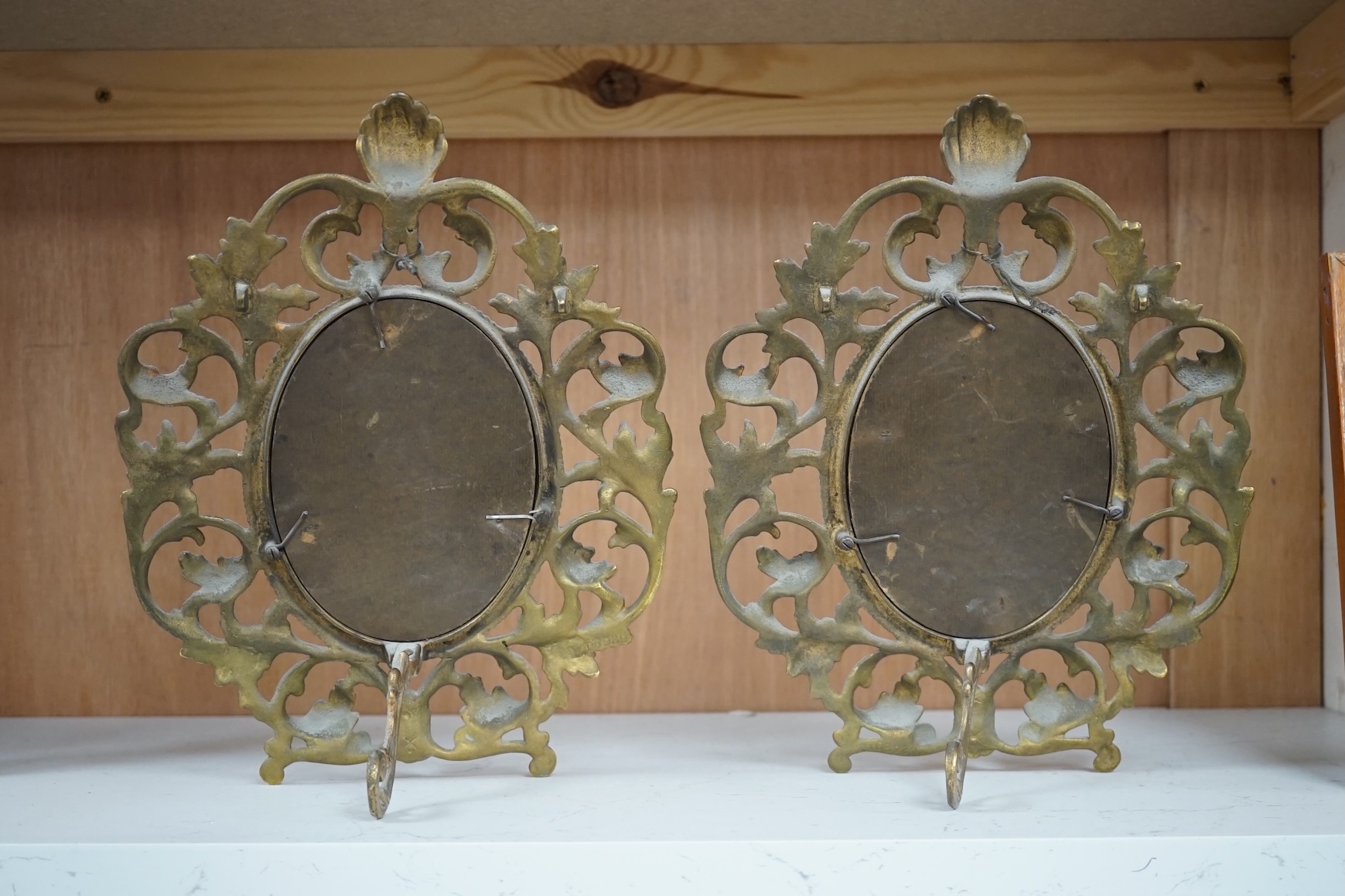 A pair of decorative oval ormolu easel framed mirrors, 28cm. Condition - good